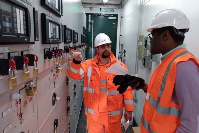 Two Amey employees working within a control room.