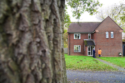 People standing outside a house